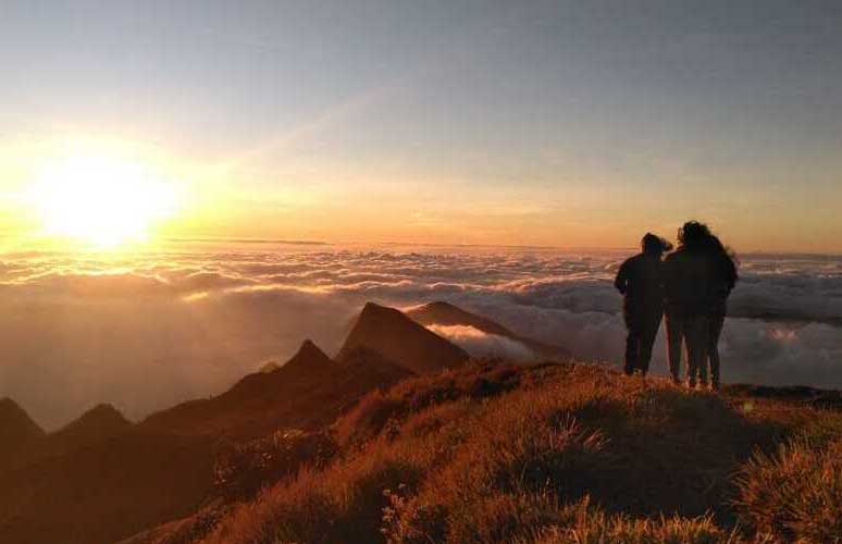 Kolukkumalai sunrise view in Munnar Kerala with misty hills