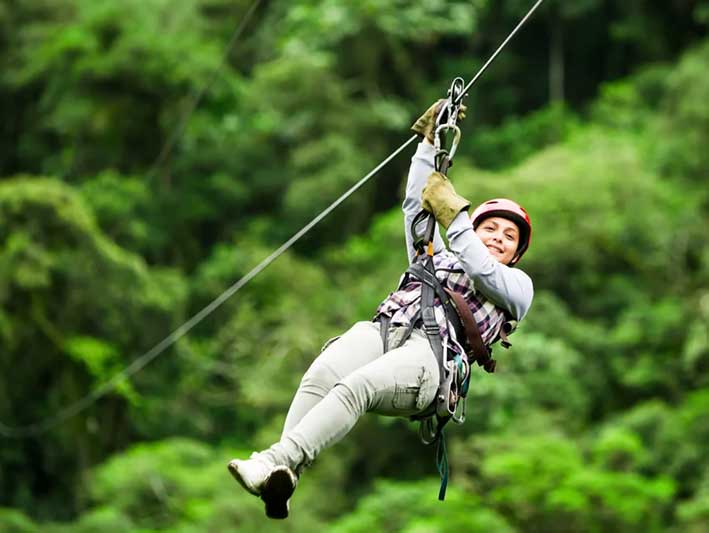 Tourist enjoying zipline adventure in Munnar Kerala hills