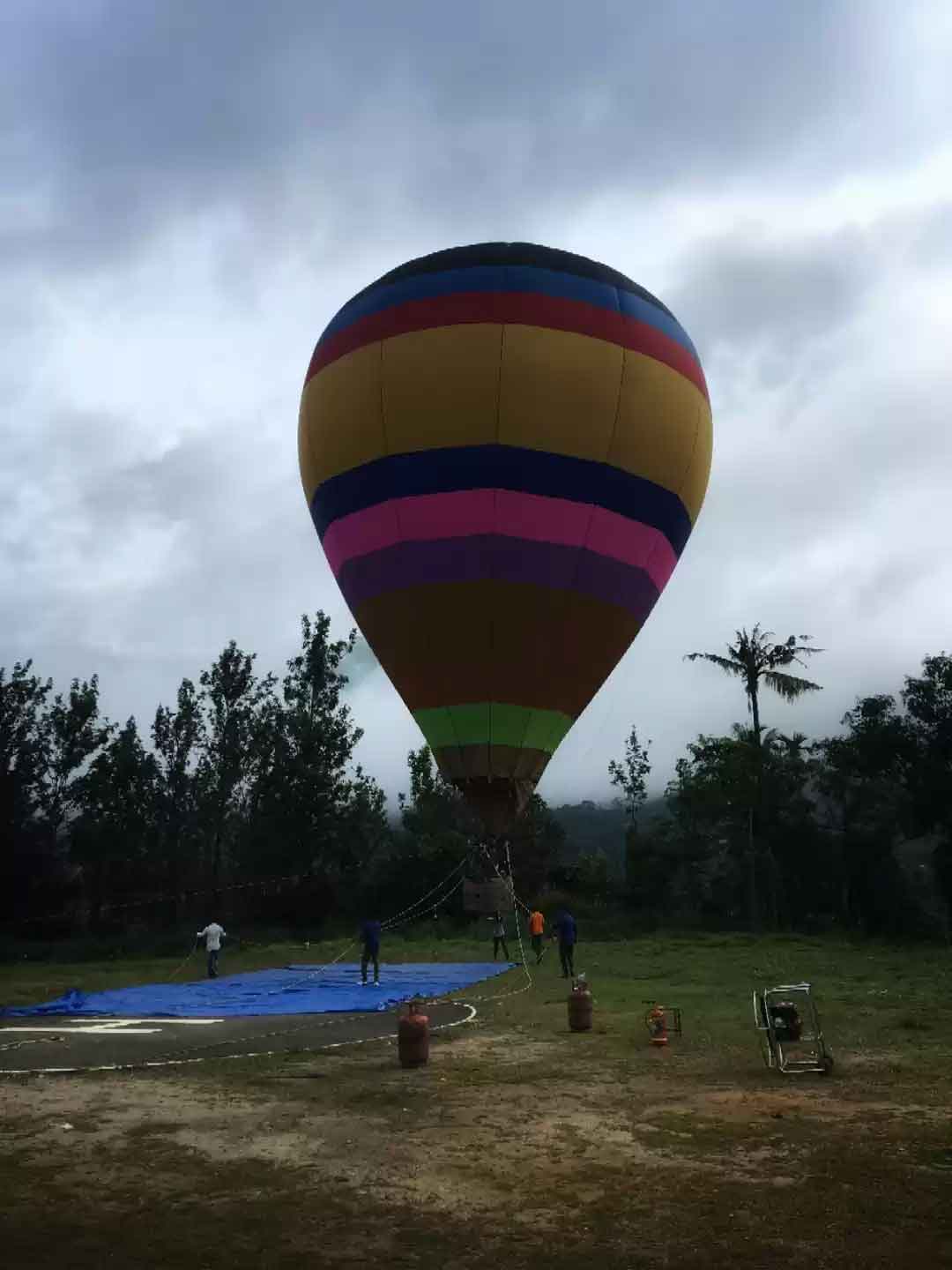 Hot air balloon flying over Munnar mountains