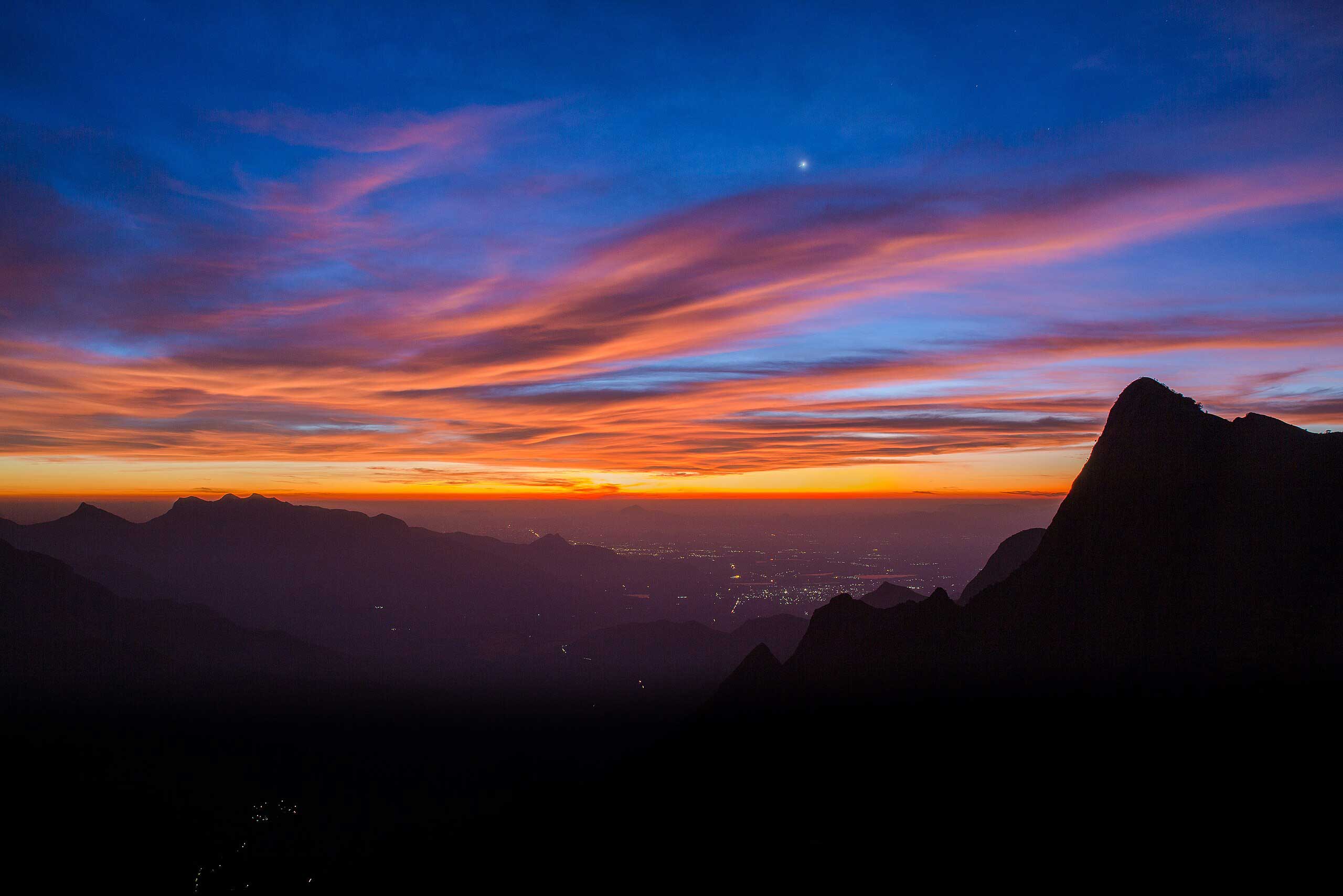 Kolukkumalai sunrise over tea estates and misty hills