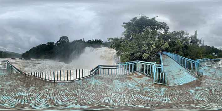 Tourists enjoying the beauty of Ripple Waterfall in Munnar