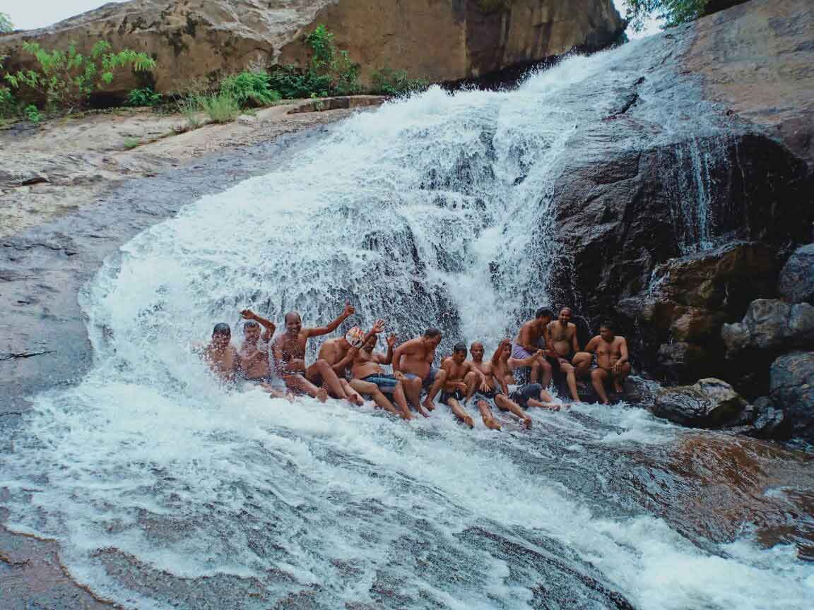 Virivara Waterfall cascading through rocks surrounded by green forest near Munnar